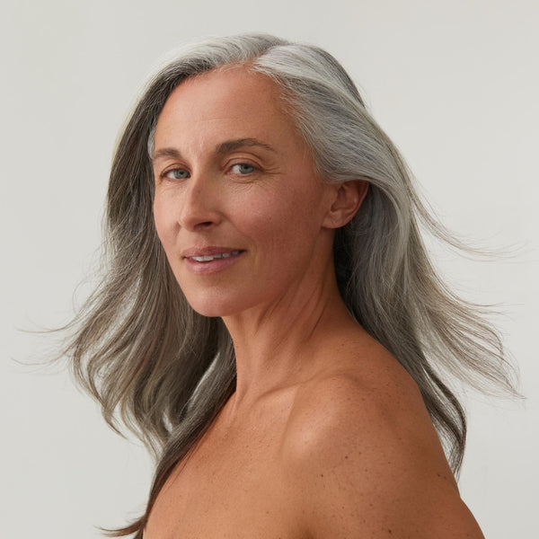 Woman smiling with long grey hair