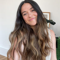 Woman with long, dark hair smiling